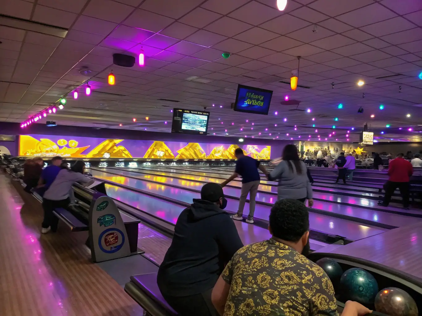 A diverse group of adults participating in a bowling league night, showcasing the social and competitive aspects of the activity.