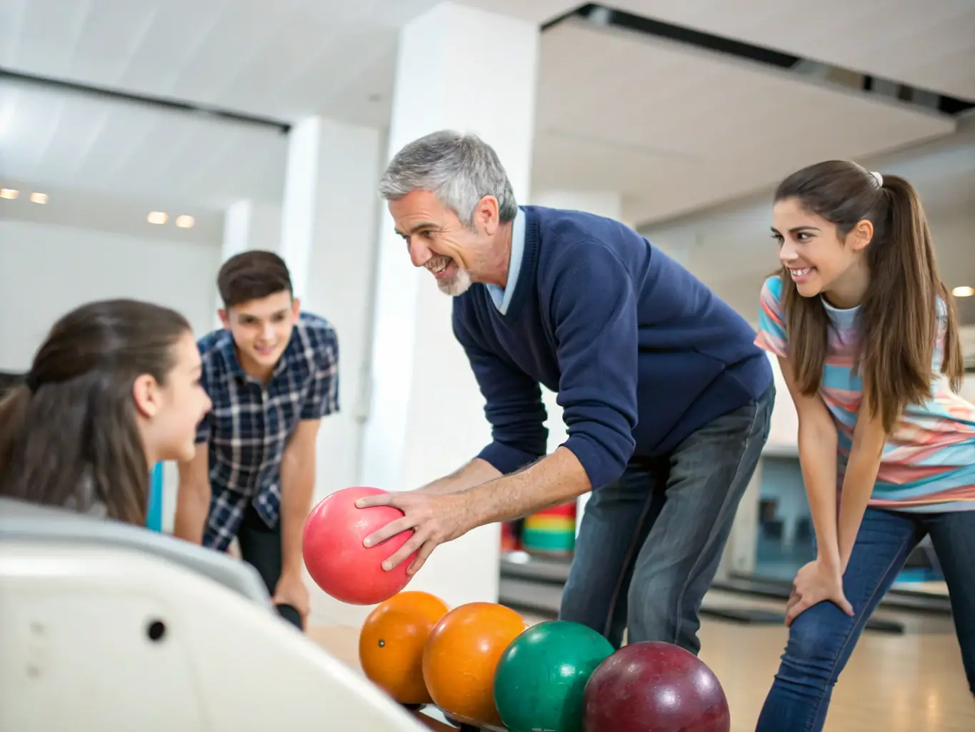 A coach providing personalized bowling instruction to a young bowler, focusing on technique and skill development.